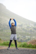 © AW/peopleimages.com - Enjoying a morning jog. Full length of a young jogger stretching in the morning and admiring the view.