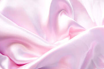 Abstract background of luxury pastel pink fabric, folded textile or liquid wave or wavy folds silk texture satin material