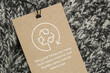 © triocean - Close up of clothing tag with recycle icon. Recycling products concept. Zero waste, suistainale production, environment care and reuse concept.