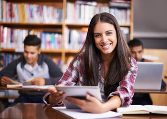 Aufkleber - Getting down to some studying. Portrait of an attractive female student using her digital tablet during class.