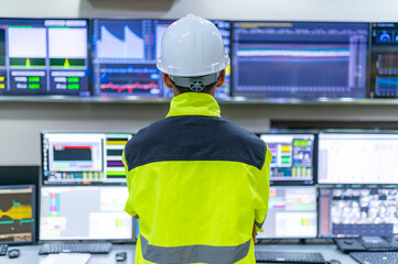 Wall Mural - Engineer working at control room,Manager control system,Technician man monitoring program from a lot of monitor