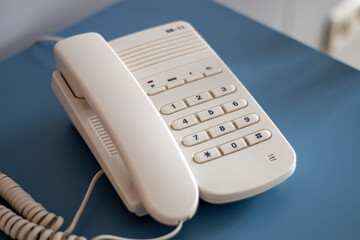 analogue desktop telephone with keys and cable