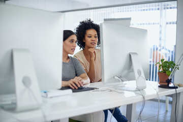 Canvas Print - What do you think of this layout. two creative businesspeople working together on a computer in the office.