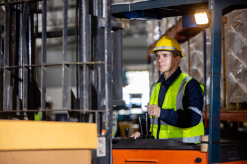 Wall Mural - Man wear safety helmet driver forklift warehouse in factory. Male worker industrial operate. control loading container box. logistics export import concept.