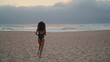 © stockbusters - Woman traveler running beach enjoying summer vacation. Girl posing near ocean