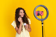 © Olena - Young blogger child recording video for blog. Teen girl speaking in front of camera for vlog. Teenager working as blogger, recording video tutorial for blog. Happy teenager, positive and smiling.