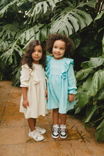 Two Cheerful Little Girls In The Botanical Garden. Spring Summer.