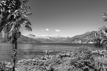  Beautiful landscape of Lake Como and the Alps mountains on the horizon as seen from Bellagio village on the Italian riviera of Lake Como, Lombardy, Italy in black and white