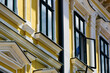 painted white wood windows. yellow stucco elevation. old classic architecture. decorative elements. buildings, architecture concept. travel and tourism. urban scene in Europe. 