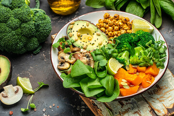 Sticker - Green vegetable vegan salad with avocado, mushrooms, broccoli, spinach, chickpeas, pumpkin. Healthy vegetarian food concept. top view