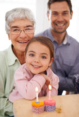 Poster - Gran makes the best cupcakes. Portrait of a happy three-generational family celebrating a birthday at home.