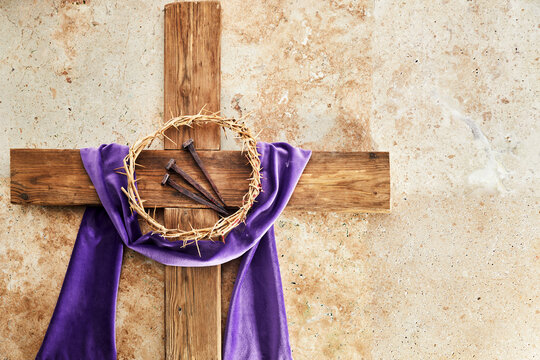 lent season, holy week and good friday concept. cross with three nails and crown of thorn on stone b