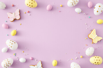 Wall Mural - Easter decor idea. Top view photo of colorful easter eggs butterfly shaped cookies and sprinkles on isolated violet background with empty space in the middle