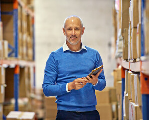Aufkleber - The right man for the job. Portrait of a warehouse manager with a tablet standing amongst shelving.