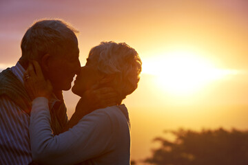 Canvas Print - Tender love. an elderly couple sharing a romantic moment at sunset.