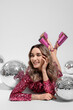 © New Africa - Beautiful woman in pink dress among disco balls on white background