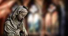 Captivating Image Of St. Mary Praying Amidst Blurry Church Background