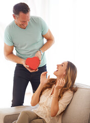 Canvas Print - Happy valentines day baby. a handsome man surprising his wife with a gift on valentines day.