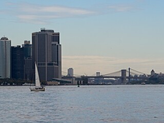 Wall Mural - Looking back on Manhattan from the Hudson River and Liberty Island, as the towering high rises of Lower Manhattan loom above the river