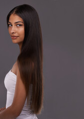 Showing off her luscious locks. Portrait of a beautiful young woman posing in the studio.