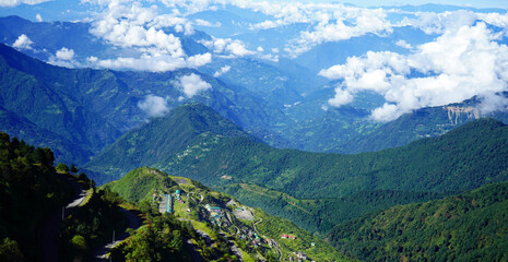 Wall Mural - Landscape of Green Himalayan Range of Zuluk Village with Blue Sky and White Clouds from top of Silk Route Sikkim