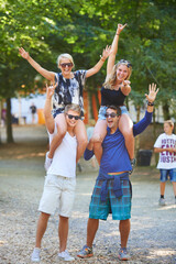 Poster - Getting into the spirit of the festival. a group of friends having fun together at an outdoor festival.