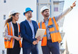 © Joanrae/peopleimages.com - Architecture people pointing for outdoor planning, teamwork or collaboration at building construction site or development. Engineering, property and business contractor or industry person with group