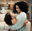 © Allistair/peopleimages.com - Family, love and child hug mom for Mothers Day, home bonding or embrace in house living room. Care, loving and happy mother or woman smile with female youth kid, girl or daughter in apartment
