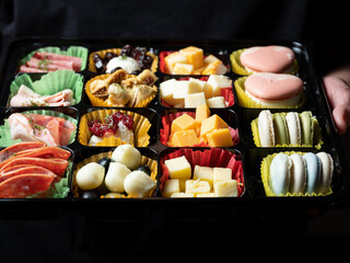 Canvas Print - A variety of cheeses, raw hams and sweets	