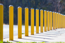 Yellow pole road barriers on concrete.