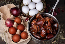 Coloring chicken eggs for Easter with onion skins. Easter Sunday. Healthy food. Dark key, rustic. Selective Focus