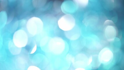 Wall Mural - Blinky Backdrop Of Blue And White Bokeh. Abstract movement of light blue defocused circles and light reflexes. Glowing silky bokeh lights motion 4K background.