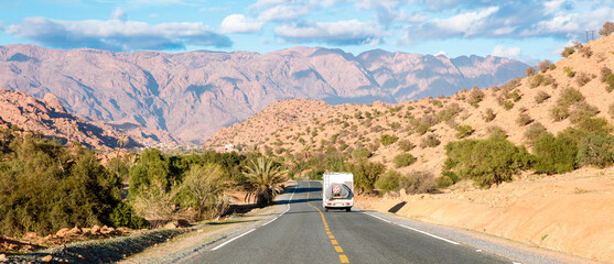 Wall Mural - travel destination in Morocco- Motor home on the asphalt road in africa