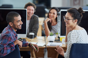 Aufkleber - They share a great working relationship. a group of smiling designers sitting at their workstations in an office.