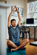 © Drazen - Athletic man doing breathing exercise while practicing Yoga at home.