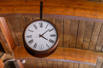 Train station with clock hanging on ceiling