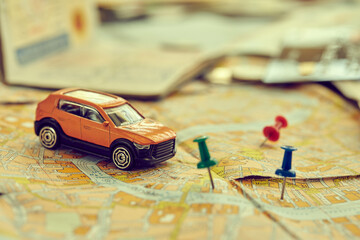 travel concept - small toy car on the map