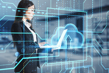 Canvas Print - Young european businesswoman using laptop with glowing circuit cloud computing hologram on blurry office interior background. Database and server concept. Double exposure.