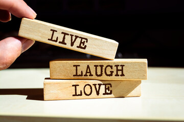 Wall Mural - Wooden blocks with words 'Live Laugh Love'.