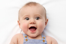 Close-up Portrait Of Funny Chubby Baby With Surprised Expression