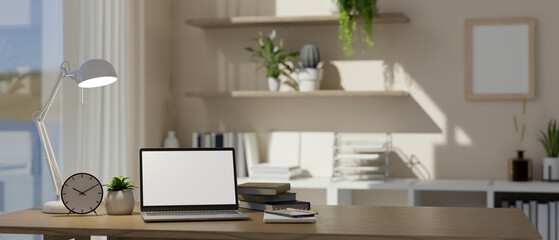 laptop mockup and decor on wood table in modern bright home office. workspace concept
