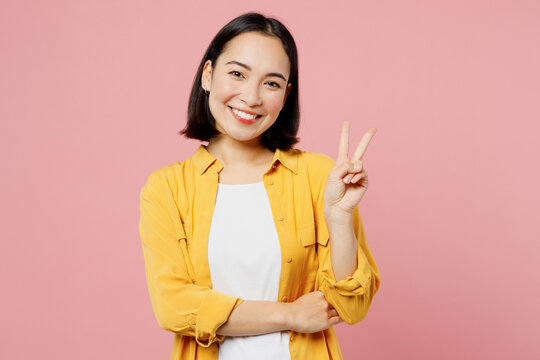 young smiling happy cheerful friendly woman of asian ethnicity wear yellow shirt white t-shirt showi