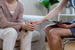 © eakgrungenerd - Psychiatrist holds patient's hand to encourage, female psychotherapy treatment support. women have mental symptoms illnesses and depression.