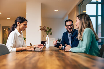 Group of smiling  business people working together in the meeting room.