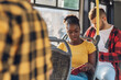 © Zamrznuti tonovi - African american woman riding in a bus and reading a book