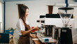 © Nuttapong punna - Asian female coffee shop owner in a coffee shop.