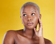 © Joanrae/peopleimages.com - Beauty, skincare and serious with black woman in studio for cosmetics, satisfaction and self care. Glow, dermatology and confidence with female model on yellow background for natural and treatment