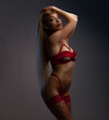 © oleg_ermak - Sexy woman with long blond hair in red lingerie posing over studio backround. Luxury style. Beautiful temptation model.