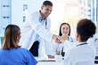 © Jessica L J/peopleimages.com - Handshake, doctors and medical meeting in agreement, collaboration and smile of teamwork, welcome or deal. Happy healthcare employees shaking hands in hospital partnership, greeting or clinic success