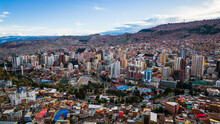 Aerial Drone Fly Above La Paz, Bolivia,  Crowder Metropolitan City, Houses, Skyscrapers And Andean Cordillera Mountain Range In The Background